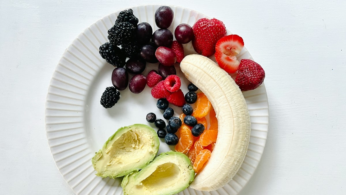 a white plate topped with fruits and vegetables